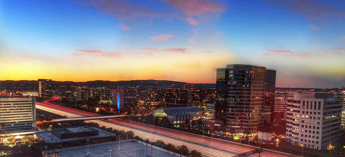 A photo of a colorful sunset over the Irvine city line, where Aldrich Advisors offers audit and assurance, business advisory, employee benefits, private client, retirement planning, tax planning, technology, and wealth management services in Irvine and Orange County.