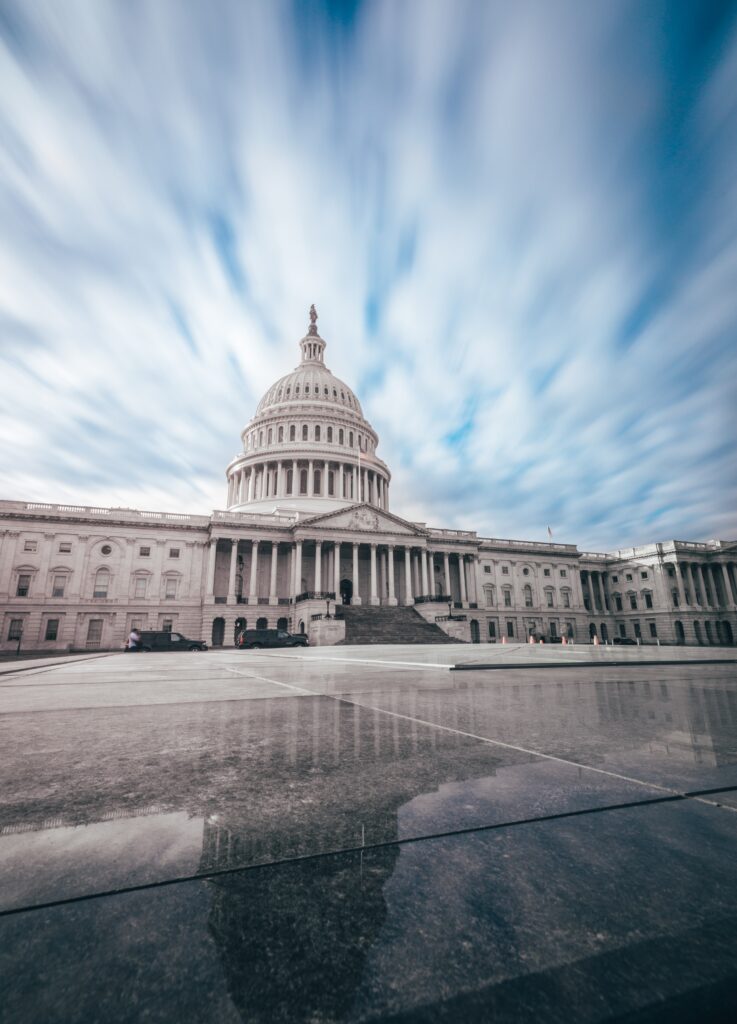 The United States capitol building on a scattered cloudy day.