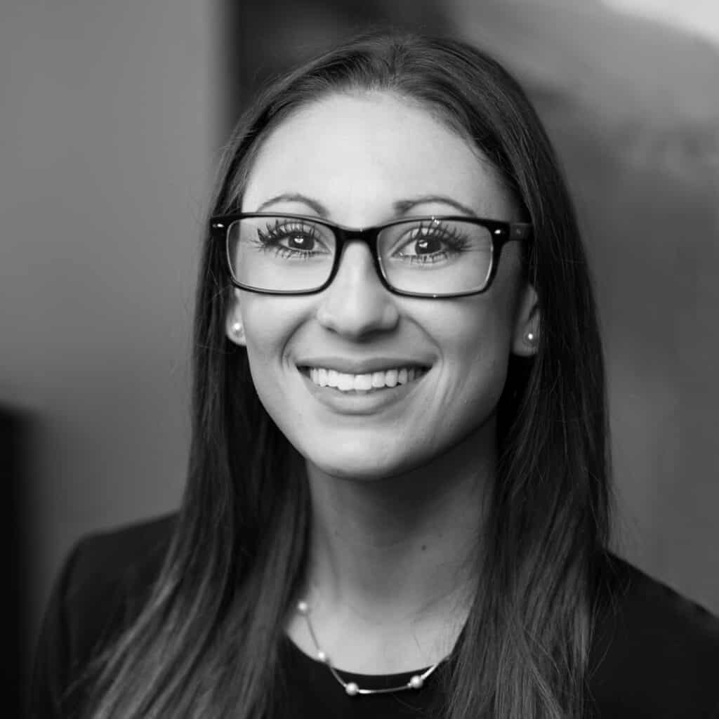 Megan Fennessy's headshot in black and white in office space.