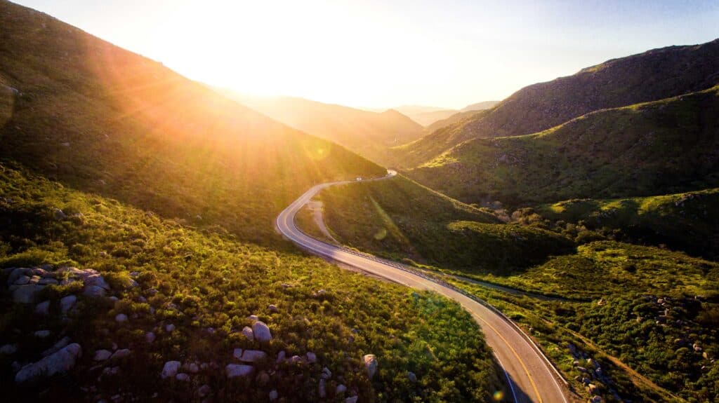 valley with road and beam of sunshine coming through