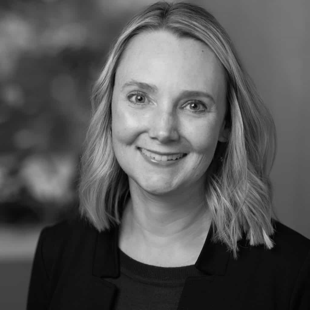 Wendy Jordan's headshot in black and white in an indoor office space