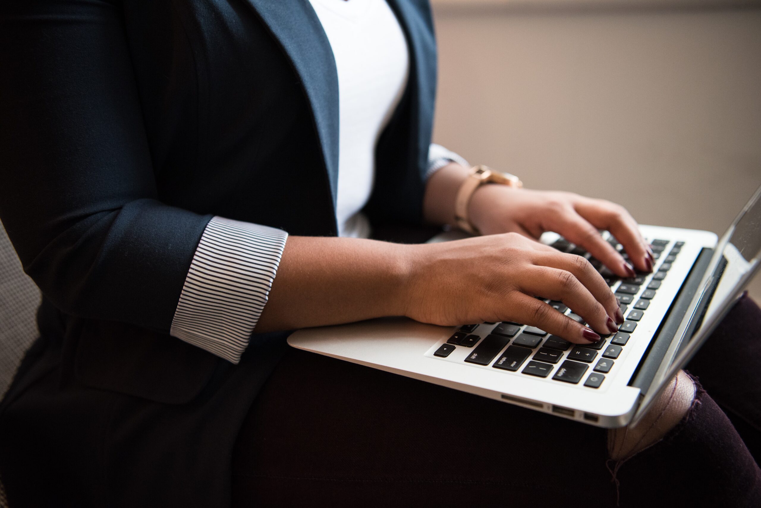 Business woman researching canadian tax requirements on her laptop