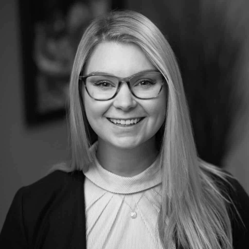 Jillian Altrichter's headshot in black and white in office space.