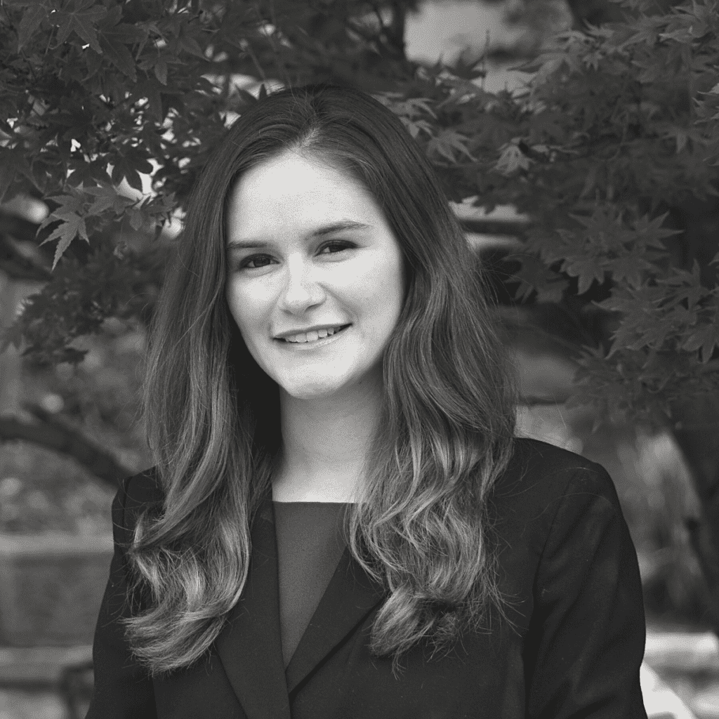 Melissa Gonzales' headshot in black and white in an outdoor space.