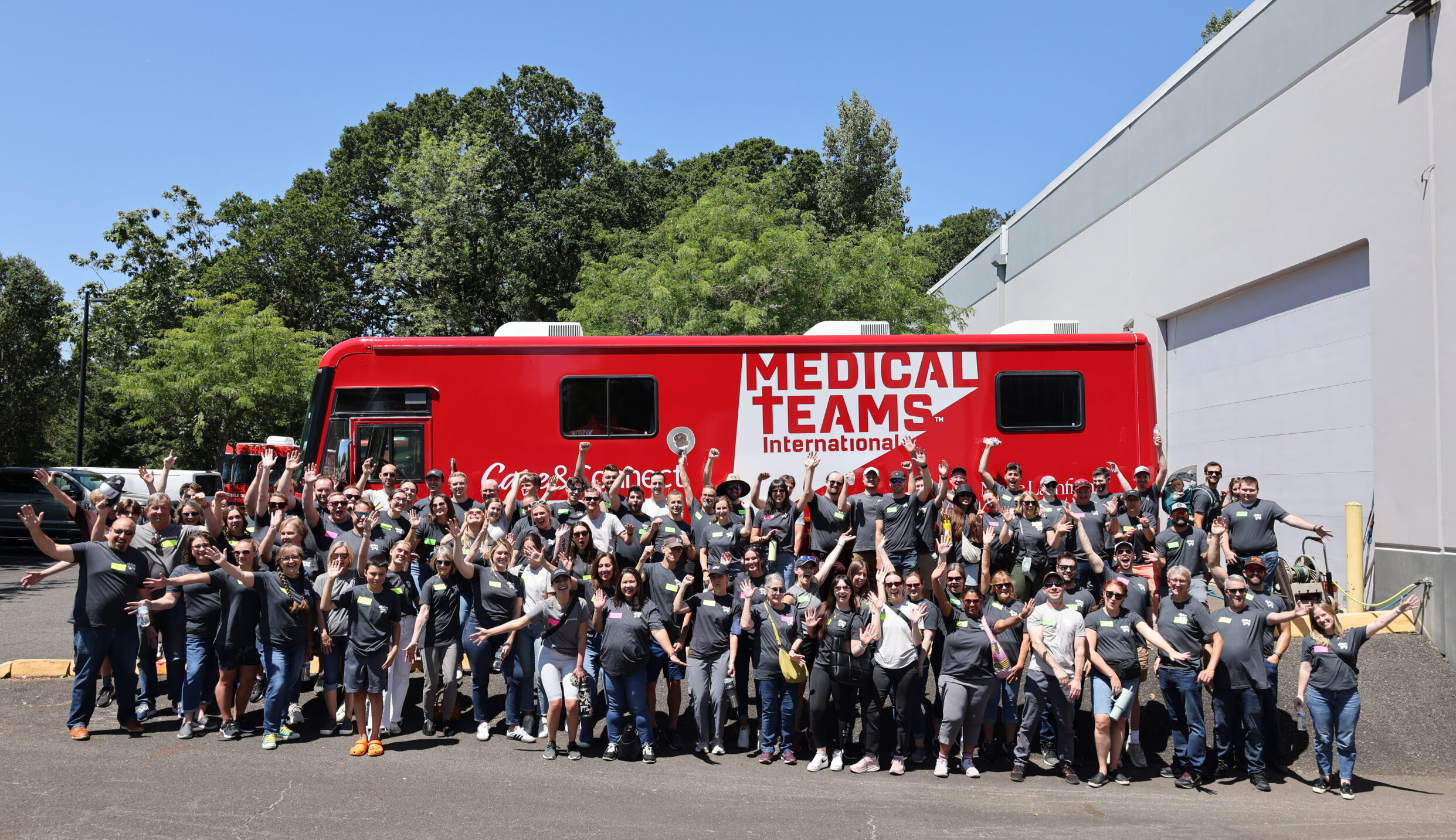 Aldrich employees gathering in front of a Medical Teams International van, where they volunteered for Action Day 2024.