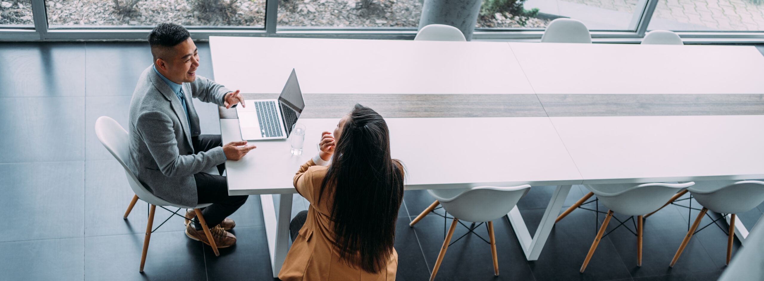 Two people meeting across a table, as Aldrich's Eric Seifert recommends for all businesses to finish their year strong.